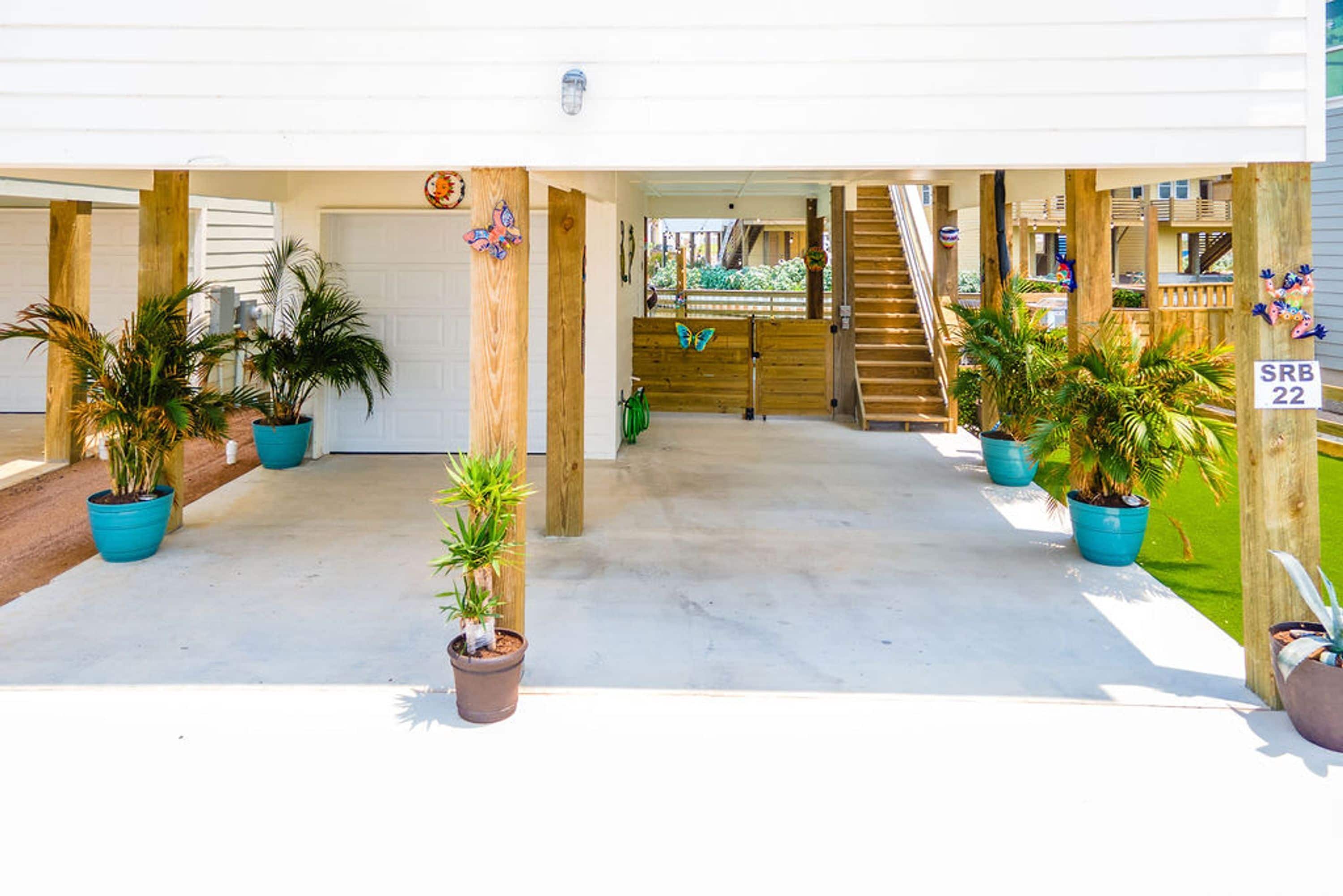 A covered outdoor area with potted plants, a wooden staircase, and a sign indicating 'SRB 22'.