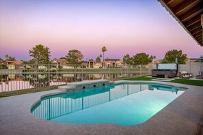 A swimming pool with a view of a lake and houses in the background. - Lakeside 5BR Retreat Pool Hot Tub (Glendale)