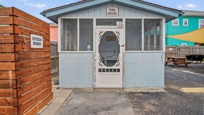 A small, single-story building with a sign reading 'FISH HOUSE' and a 'PRIVATE FISH HOUSE BY BOARD OF DIRECTORS' sign. - Seagull 26- Newly Renovated Close to Beach (Port Aransas)