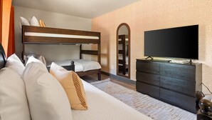 A bedroom with a bunk bed, a flat-screen TV, a dresser, and patterned wallpaper. - The Sedona Sanctuary Hot Tub Unbeatable Views (Sedona)