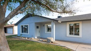 A modern two-story house with a garage, a front porch, and a well-maintained lawn. - Backyard Pickleball Hottub Pool Gameroom (Phoenix)