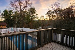 A wooden deck with a pool, surrounded by a white picket fence and trees. - 15 Mins to DT Asheville Pool Hot Tub Game Room (Asheville)