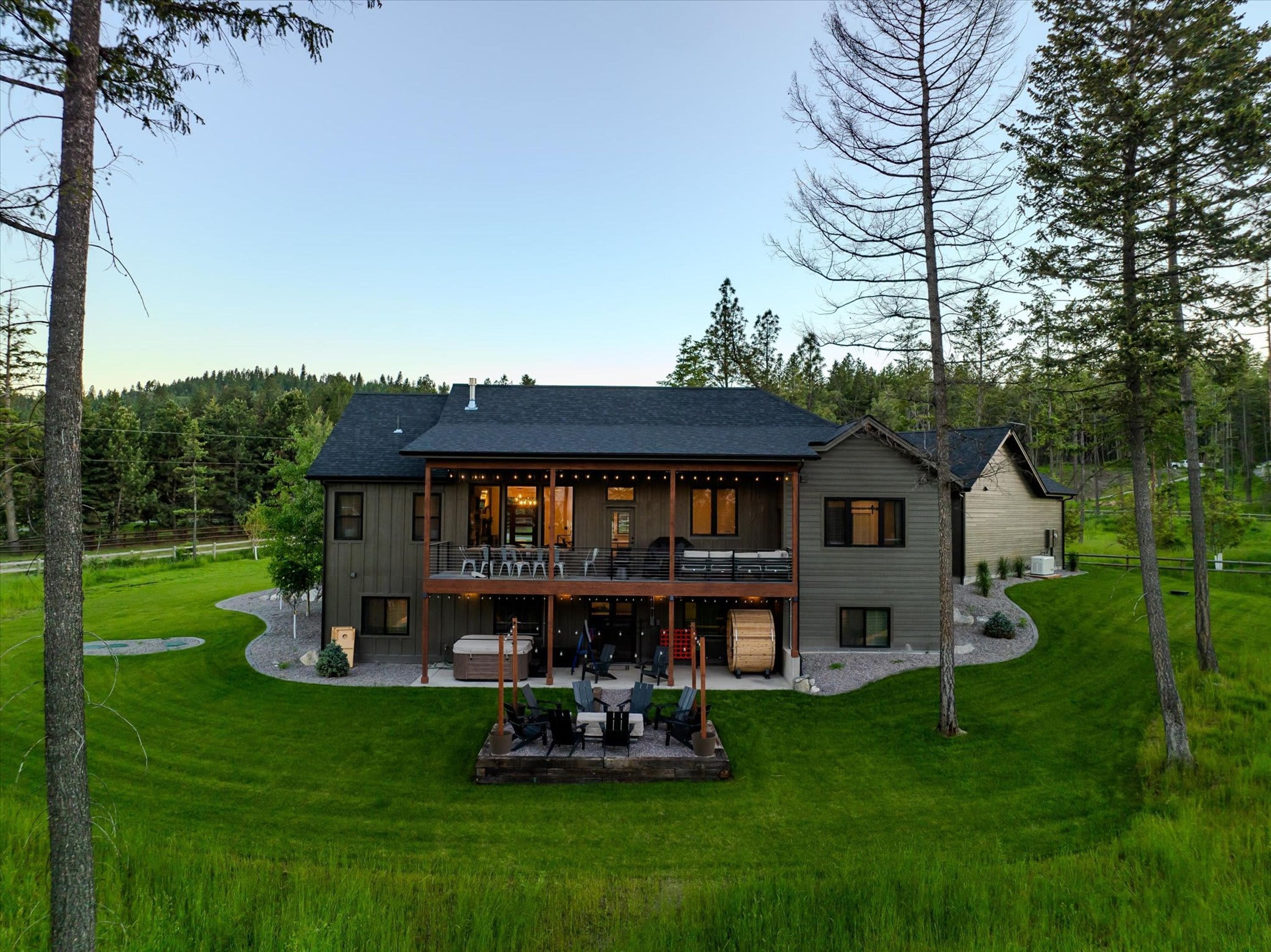 A two-story house with a balcony, a patio area, and a garage.