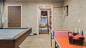 A room with a pool table, ping pong table, and a basketball hoop. - 6 Br Sleeps 16 - Game Room - Hot Tub - Firepit (Fairview)