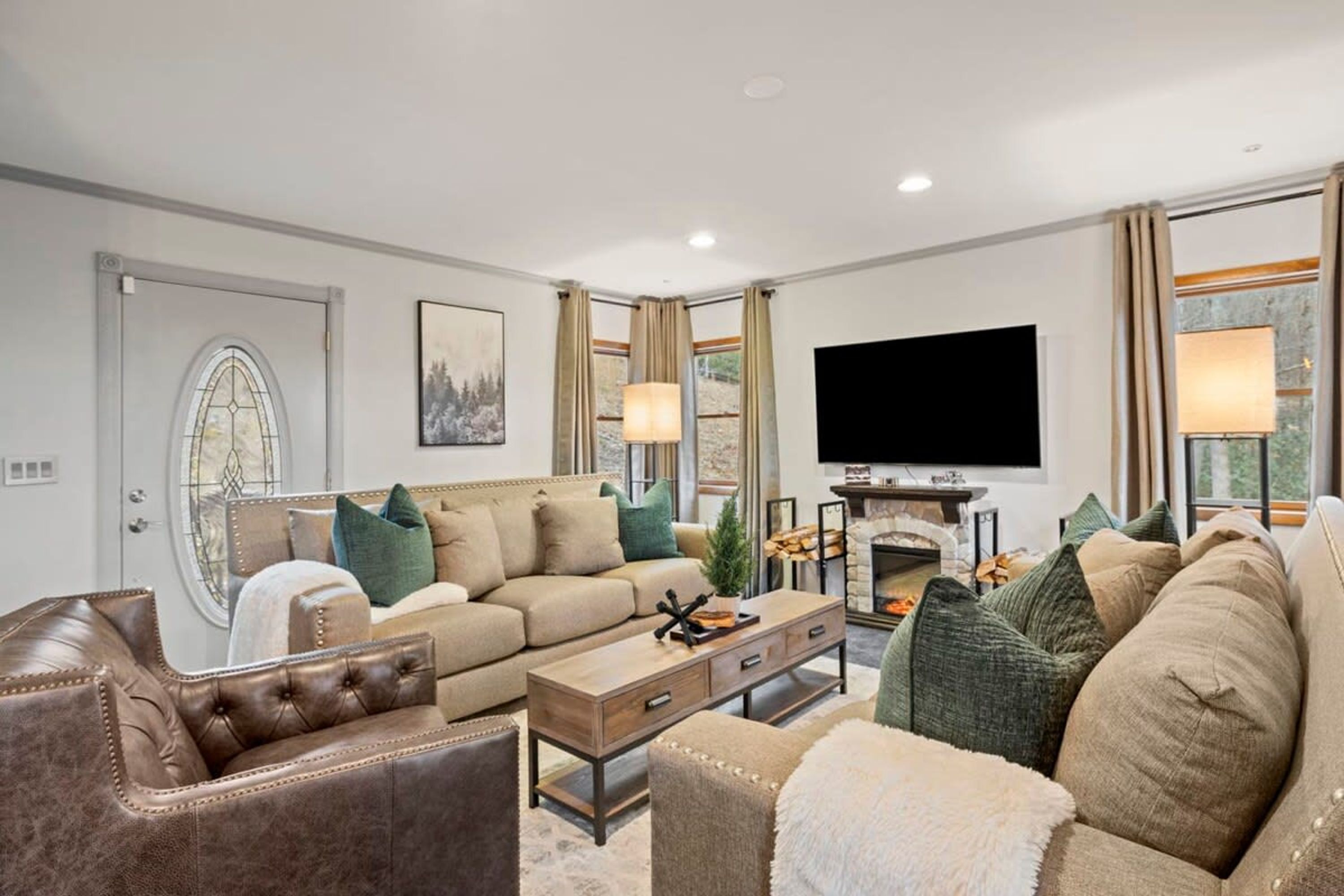 A living room with a sofa, coffee table, and fireplace.