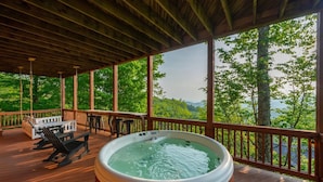 A hot tub on a wooden deck with a view of a forest and mountains. - Ski In Out Hatley Pointe Views Hottub Fire Pit (Mars Hill)
