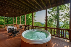 A hot tub on a wooden deck with a view of a forest and mountains. - Ski In Out Hatley Pointe Views Hottub Fire Pit (Mars Hill)