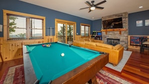 A pool table with balls, a sofa, a fireplace, and windows with blinds. - Ski In Out Hatley Pointe Views Hottub Fire Pit (Mars Hill)
