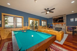 A pool table with balls, a sofa, a fireplace, and windows with blinds. - Ski In Out Hatley Pointe Views Hottub Fire Pit (Mars Hill)