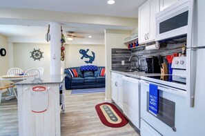 A compact kitchen with a microwave, oven, and a coffee maker. - Nauti Mermaid Private Pool Sleeps 14 Dog Friendly (Port Aransas)