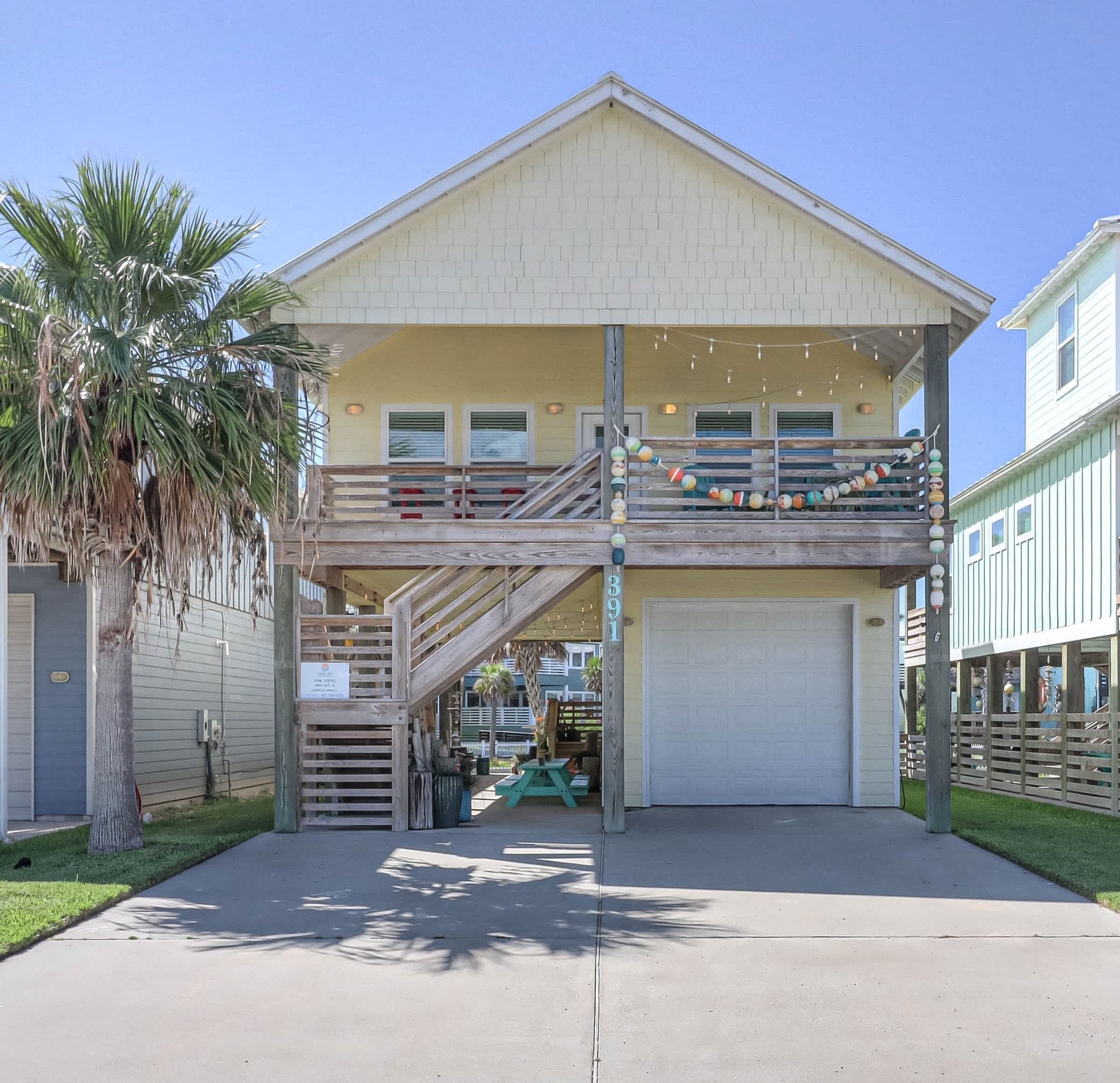 A two-story building with a covered porch and a garage.
