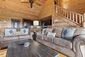 A wooden interior with a living room, kitchen, and staircase. - Mountain Views Games Hot Tub Fire Pit BBQ (Morganton)