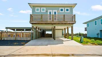 A two-story house with a covered walkway leading to the entrance.