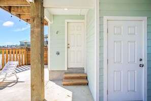 A wooden porch with a white door and a white door with a window. - Save The Ales Boardwalk Private Pool Sleeps 10 (Port Aransas)