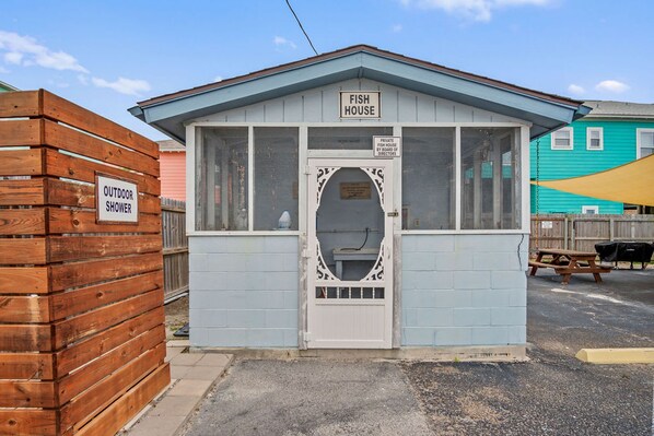 A small, single-story building labeled 'Fish House' with a sign indicating it is private property. - The Codfather- Family Friendly 2 Minute to Beach (Port Aransas)
