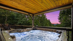 A hot tub with a wooden deck and a view of trees and a sunset. - Mountain Views-hot Tub-games-pool Foosball (Morganton)