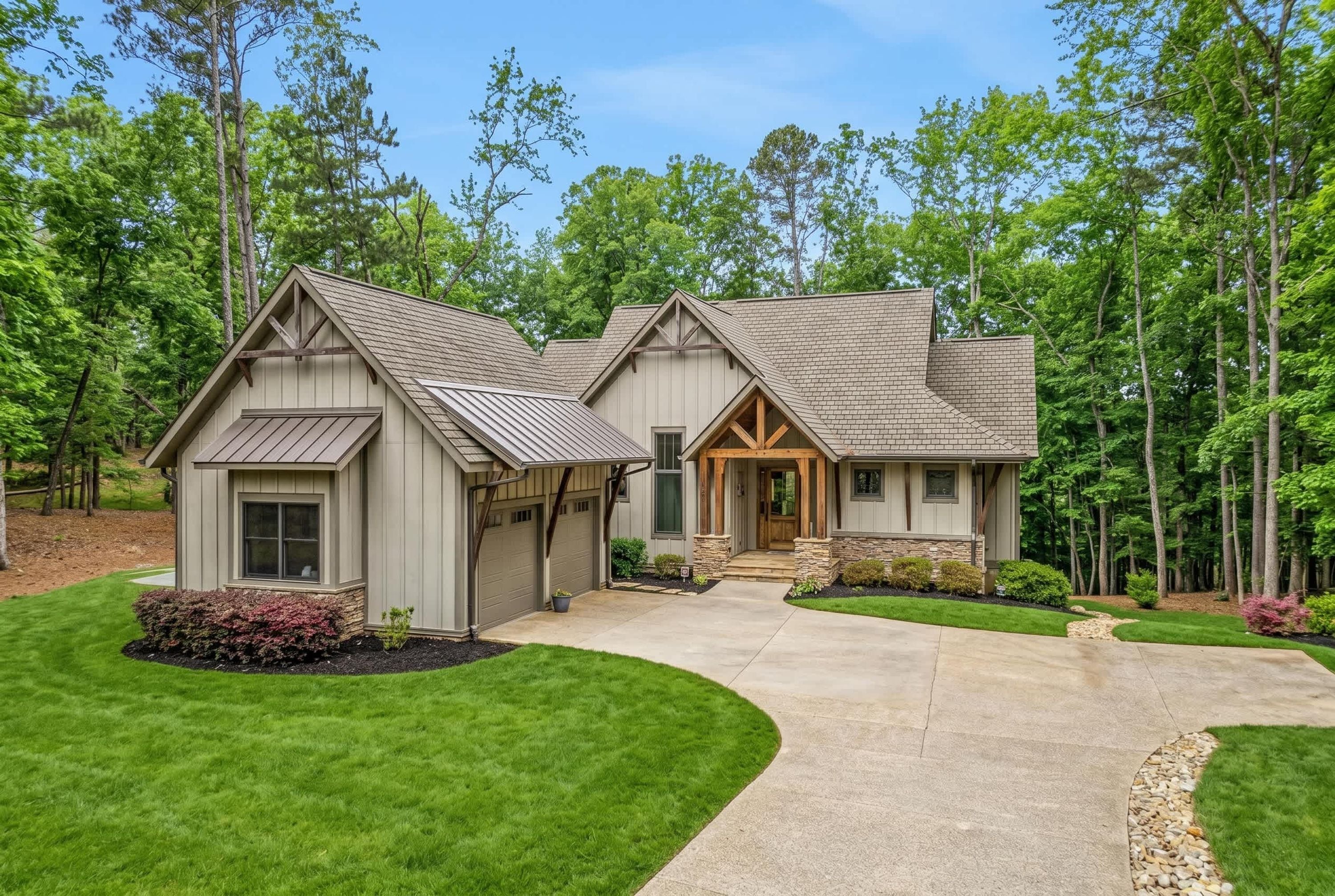 A two-story house with a covered front porch, a garage, and a well-maintained lawn.