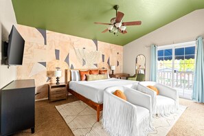 A bedroom with a bed, bedside tables, a TV, a ceiling fan, and a view of the outdoors. - Sport Court Pool Hot Tub Pool Table Fire Pit Games (Glendale)