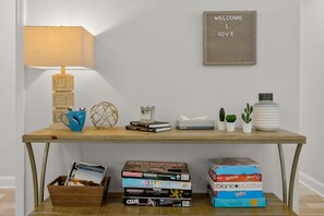 A wooden desk with a lamp, books, a tissue box, and small plants. - Sleeps 8 Private Pool Dog Friendly Balcony (Sarasota)