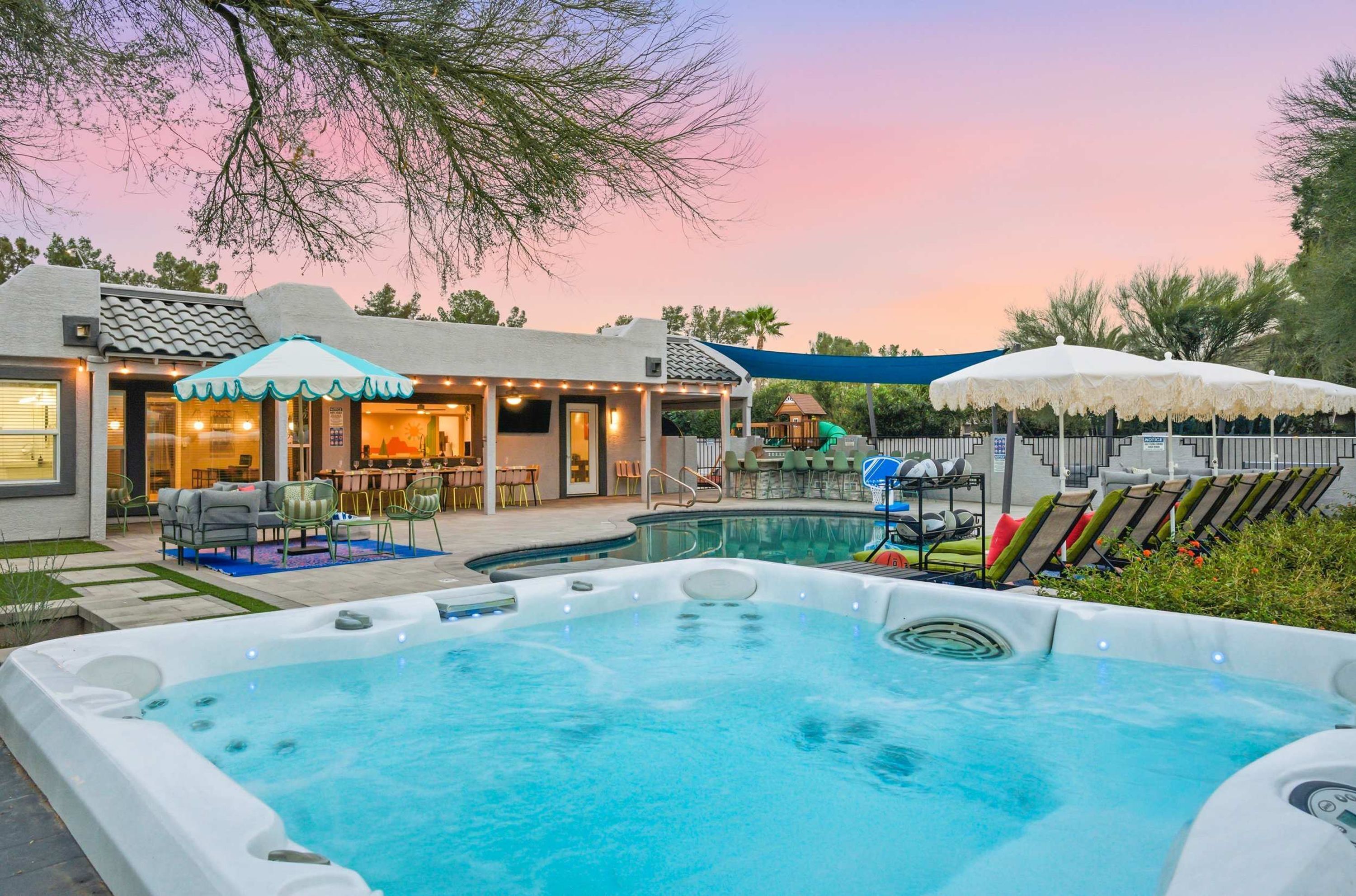 A backyard with a swimming pool, outdoor seating, and a slide.