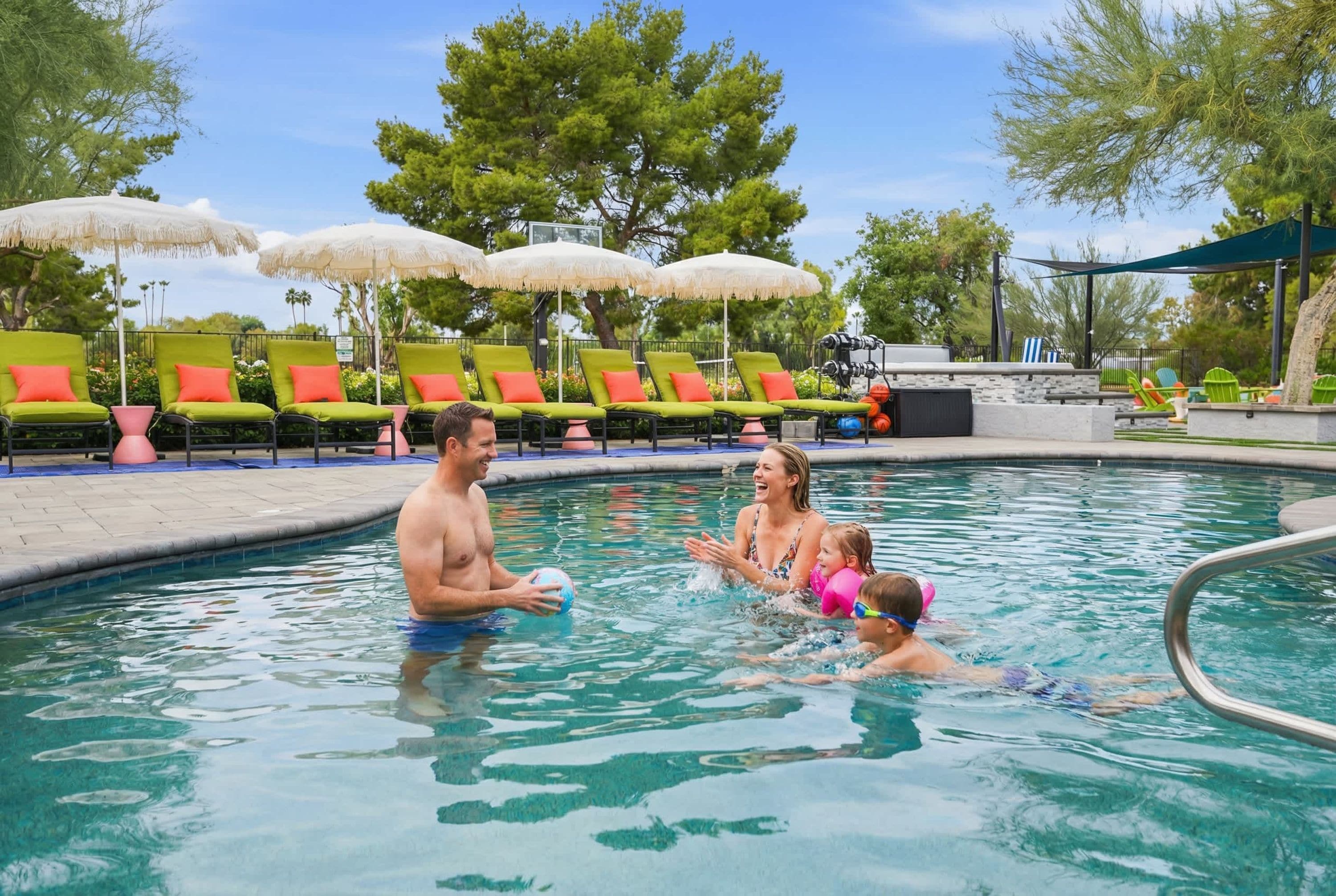 A swimming pool with lounge chairs and umbrellas.