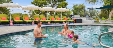 A swimming pool with lounge chairs and umbrellas.