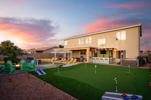 A residential property with a swimming pool, outdoor seating, and a bar area. - Bloomin Dunes - Pool Pickleball Tiki Bar (Chandler)