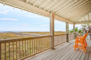 A wooden deck with a railing overlooking a beach and dunes. - Amazing Beach Views Boardwalk to Beach Shared Pool (Port Aransas)