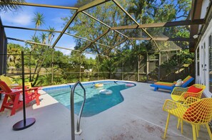 A covered outdoor swimming pool with lounge chairs and inflatable toys. - Outdoor Movie Theatre Pool Putt Putt Hot Tub (Largo)