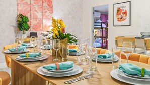 A dining area with a long table set for a meal, featuring plates, glasses, and cutlery. - Outdoor Movie Theatre Pool Putt Putt Hot Tub (Largo)