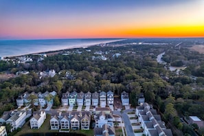 A residential area with houses, a beach, and a sunset. - Hilton Head 6BR Sleeps 18 Pool Hot Tub Firepit (Hilton Head Island)