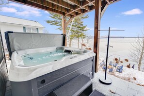 A hot tub under a wooden pergola with a view of a snowy landscape. - Lakefront Mtn Views Hot Tub Game Room More (Gilford)