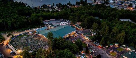 An aerial view of a large outdoor event with multiple tents and a crowd.