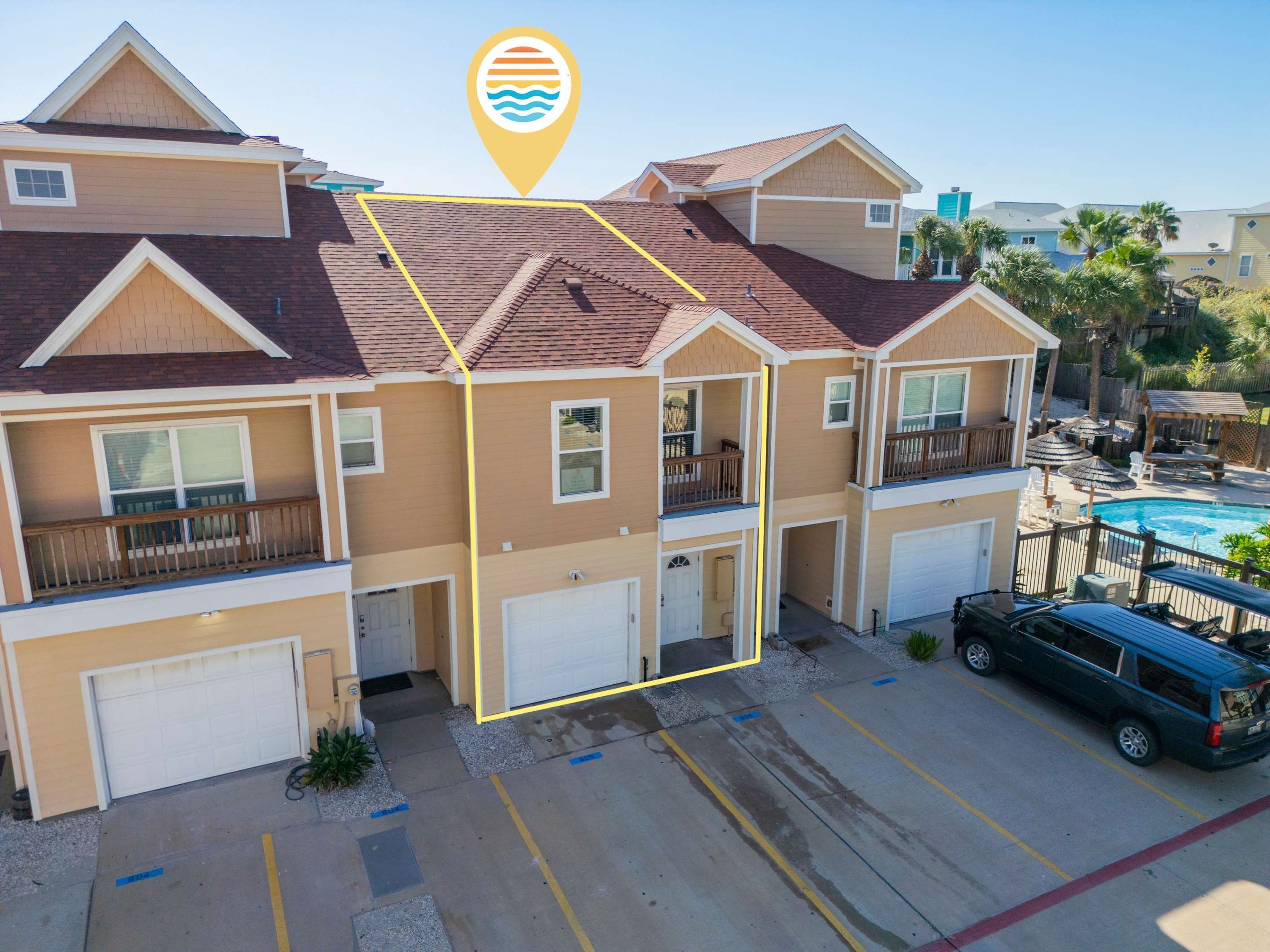 A multi-story residential building with a swimming pool, garage, and a vehicle parked in the driveway.