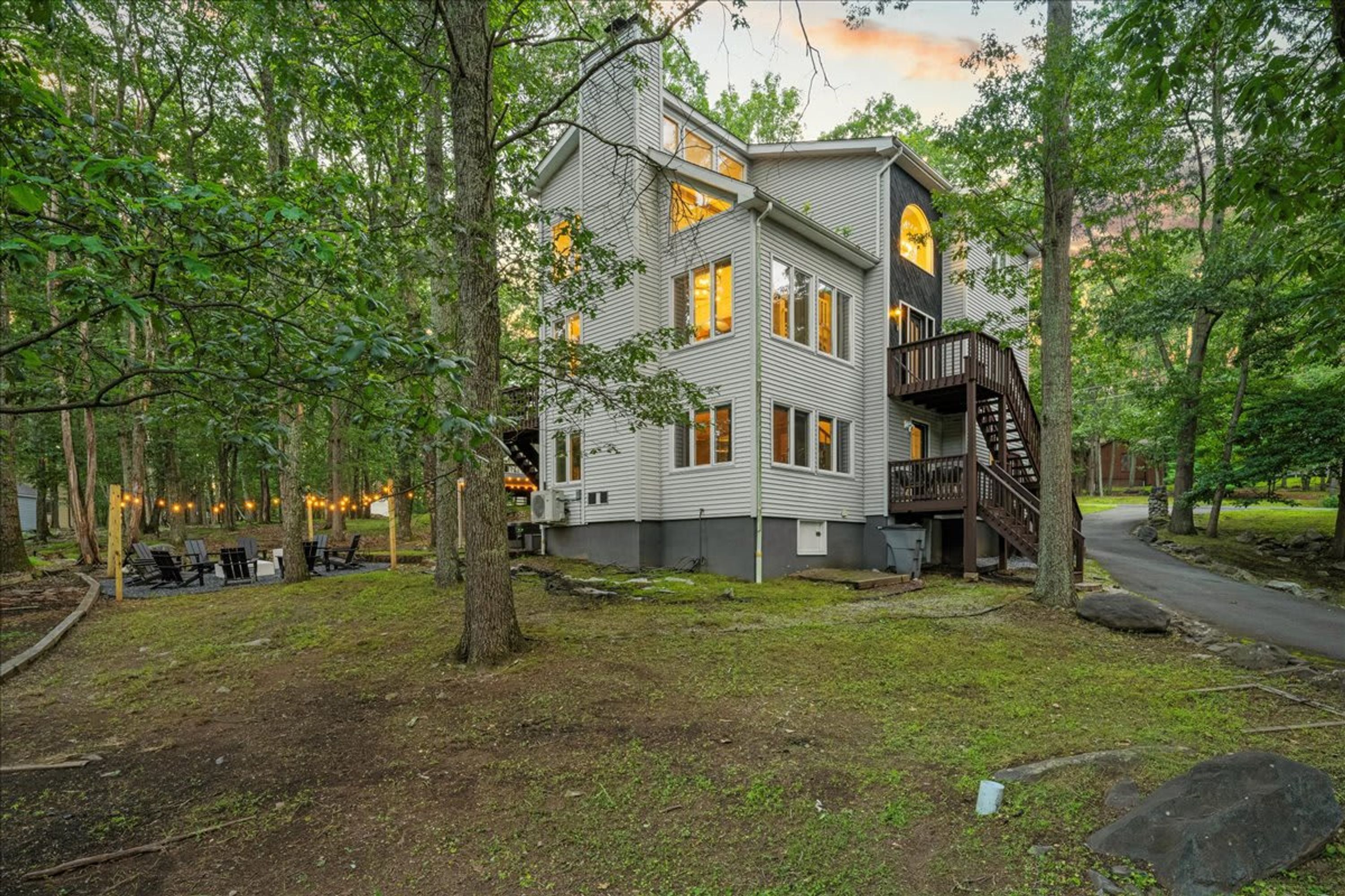A multi-story building with a deck and a staircase leading to a second level.