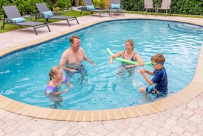 A swimming pool with lounge chairs and a tiled deck. - 2 Miles to Beach Pool Cabana Pool Table (Deerfield Beach)