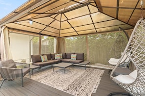 A covered outdoor seating area with a sofa, chairs, and a hanging chair. - 2 Miles to Beach Pool Cabana Pool Table (Deerfield Beach)