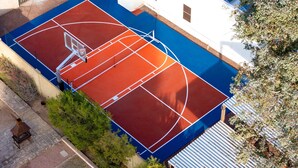 An outdoor basketball court adjacent to a building with a white exterior. - Sleeps 24 Free Heated Pool Pickleball Theater (Scottsdale)