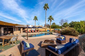 An outdoor pool area with lounge chairs, a barbecue, and palm trees. - Sleeps 24 Free Heated Pool Pickleball Theater (Scottsdale)