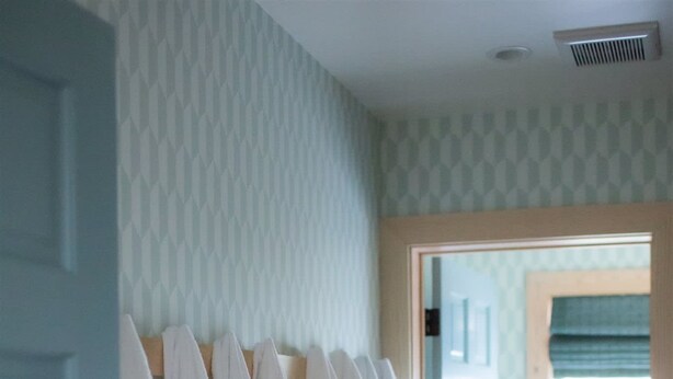 A hallway with a patterned wall and a rack of white towels. - Luxury Lakefront 5 Br Home Hot Tub Arcade (Truckee)