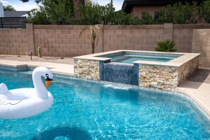 A swimming pool with a swan float and a hot tub area. - The Rusty Cactus - Heated Pool Spa More (Phoenix)