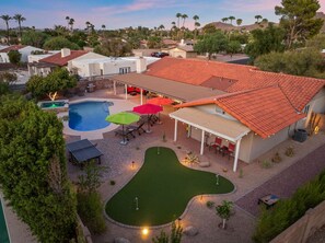 A residential property with a swimming pool, patio area, and a small putting green. - The Rusty Cactus - Heated Pool Spa More (Phoenix)