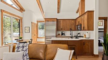 A modern kitchen with wooden cabinets, stainless steel appliances, and a central island.