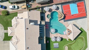 An aerial view of a residential area with a swimming pool, tennis court, and outdoor seating area. - Luxury 6BR Retreat - Pool BBQ Theater and Games (Mesa)