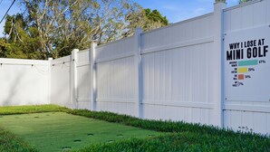 A white fence with a sign explaining reasons for losing at mini golf. - Poolside Retreat Sleeps 8 Putt Putt Hot Tub (Bradenton)