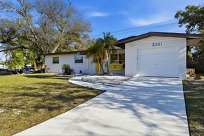 A two-story house with a garage numbered 3201, a driveway, and a lawn. - Poolside Retreat Sleeps 8 Putt Putt Hot Tub (Bradenton)