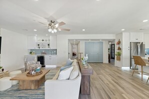 A modern living room with a sofa, coffee table, and a ceiling fan. - Sonoran Sunset Retreat Pool Games (Scottsdale)