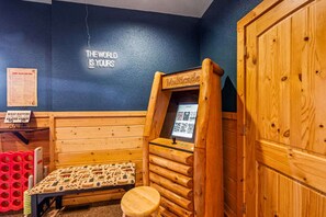 A wooden sauna room with a bench, a small stool, and a wall-mounted sauna table. - Private Mtn Views Movie Theater Hot Tub Pool Table (Sevierville)