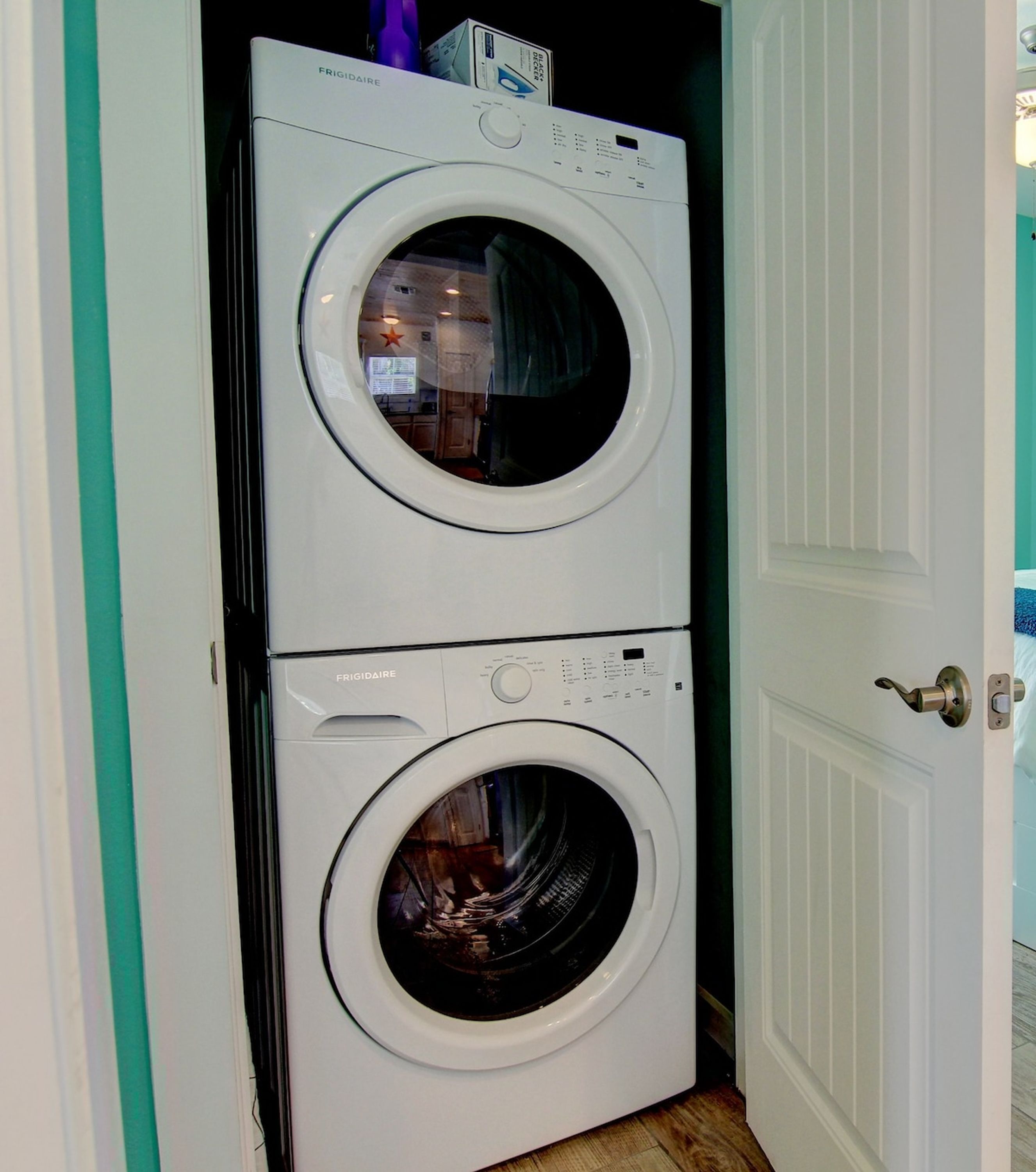 A front-loading white Frigidaire washer and dryer unit with a control panel and a door.