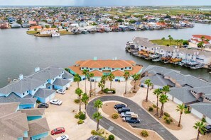 A coastal residential area with houses, a marina, and a road. - Shore Thing Waterfront Dock Family Fun (Corpus Christi)